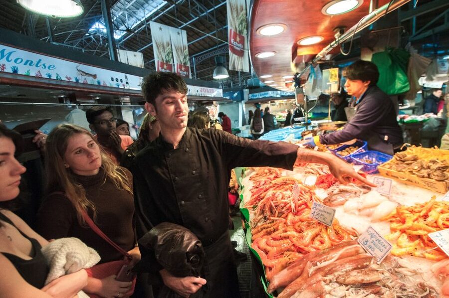 Barcelona: Paella Cooking Experience & Boqueria Market Tour - Sitting down to eat the paella