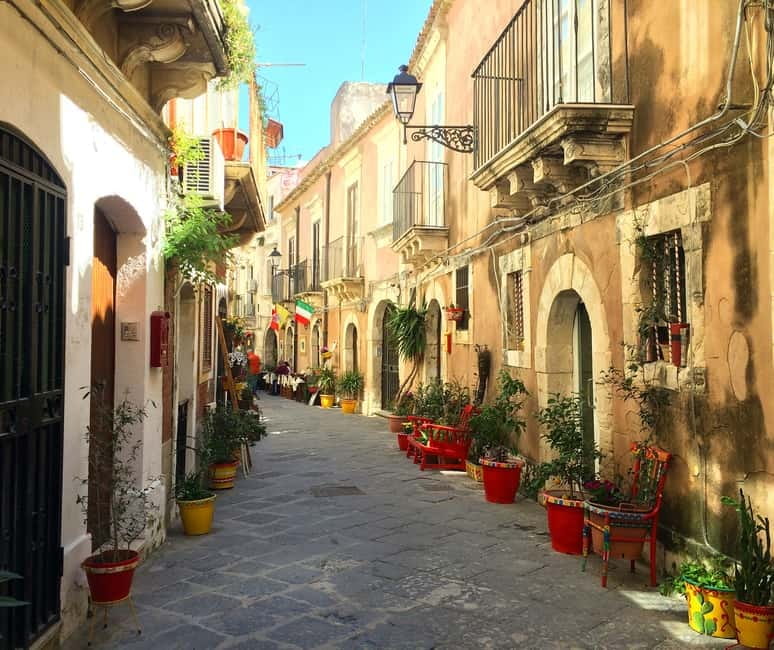From Taormina: Syracuse Tour with lunch in Food Market - Walking into Ortigia beside the Apollo Temple
