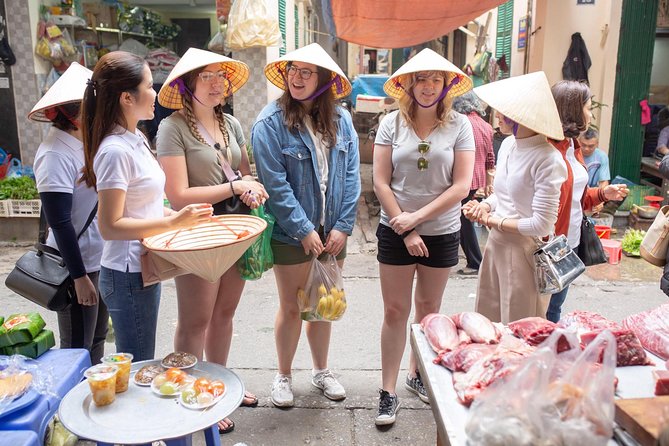 Hanoi Maya Kitchen: Traditional Cooking Class & Market Tour - Folding spring rolls at the kitchen