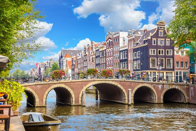 Historic Amsterdam Walking Tour: Royal Palace & Flea Markets - A canal house with a church in the attic