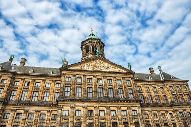 Historic Amsterdam Walking Tour: Royal Palace & Flea Markets - Oostindisch Huis and a harder chapter of Amsterdam