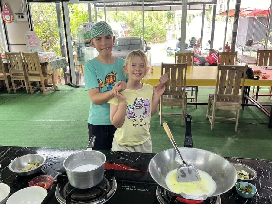 Phuket: Thai Cooking Class with Market Tour - Cooking in the open-air garden kitchen