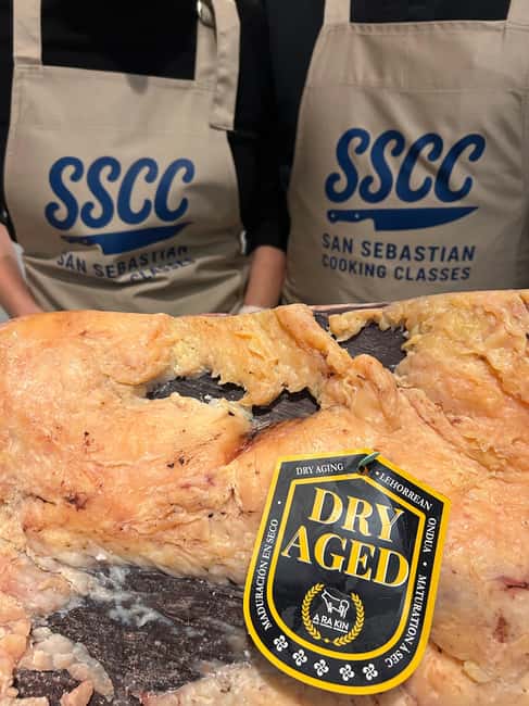 San Sebastián: Market Tour, Cooking Class, & Meal - Txuleta brings the meal to the grill