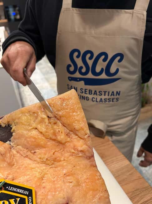 San Sebastián: Market Tour, Cooking Class, & Meal - Sitting down for a cider house-style meal
